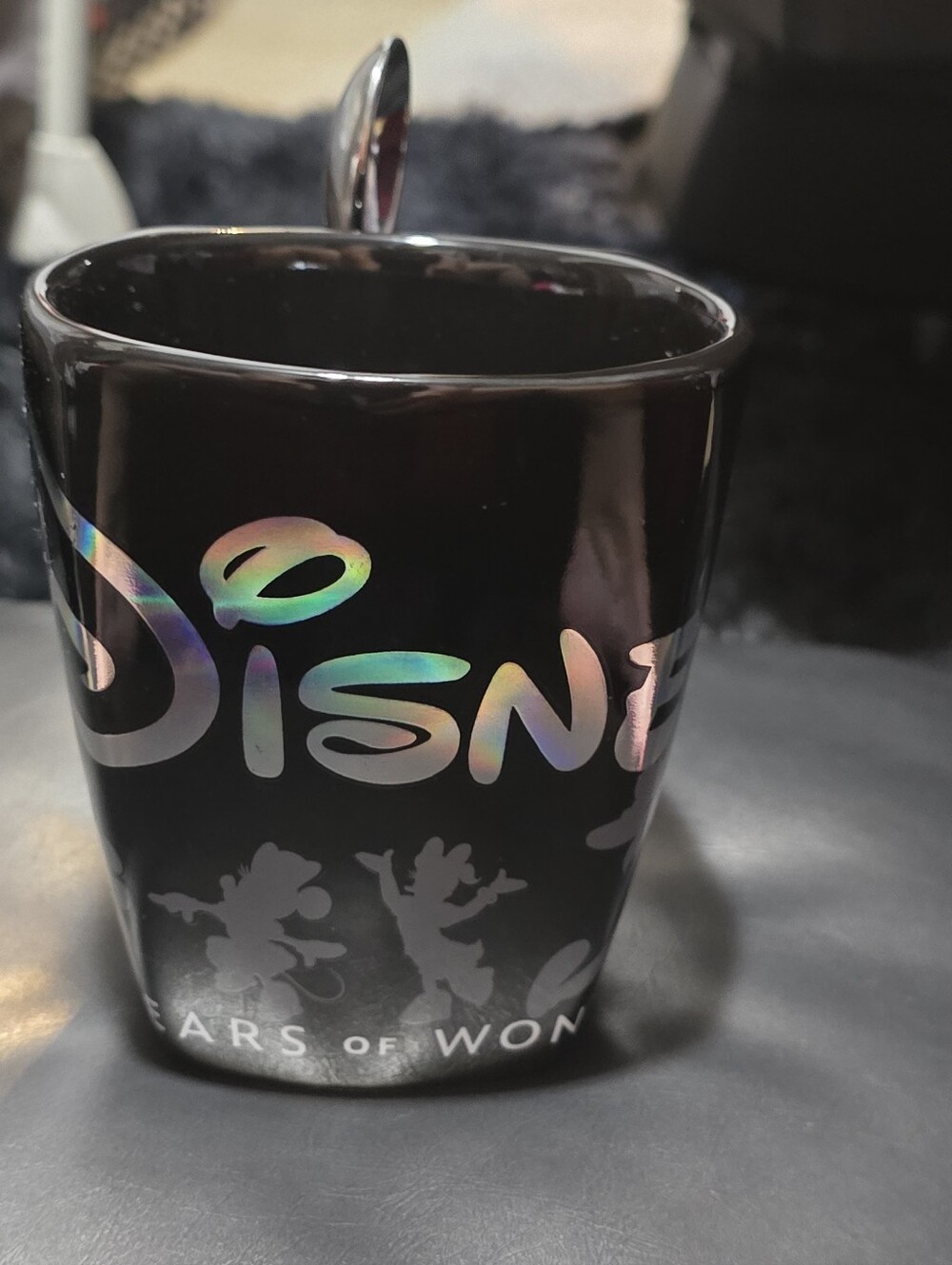 Disney 100 Years Of Wonder Black Mug with Iridescent  Logo.  Spoon In Handle
